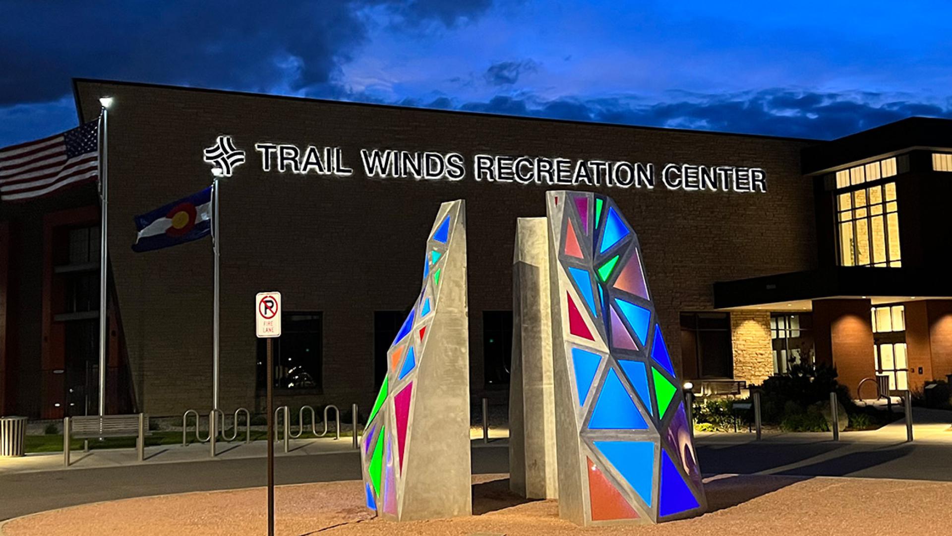 Trail Winds Recreation Center and art sculputre at night.