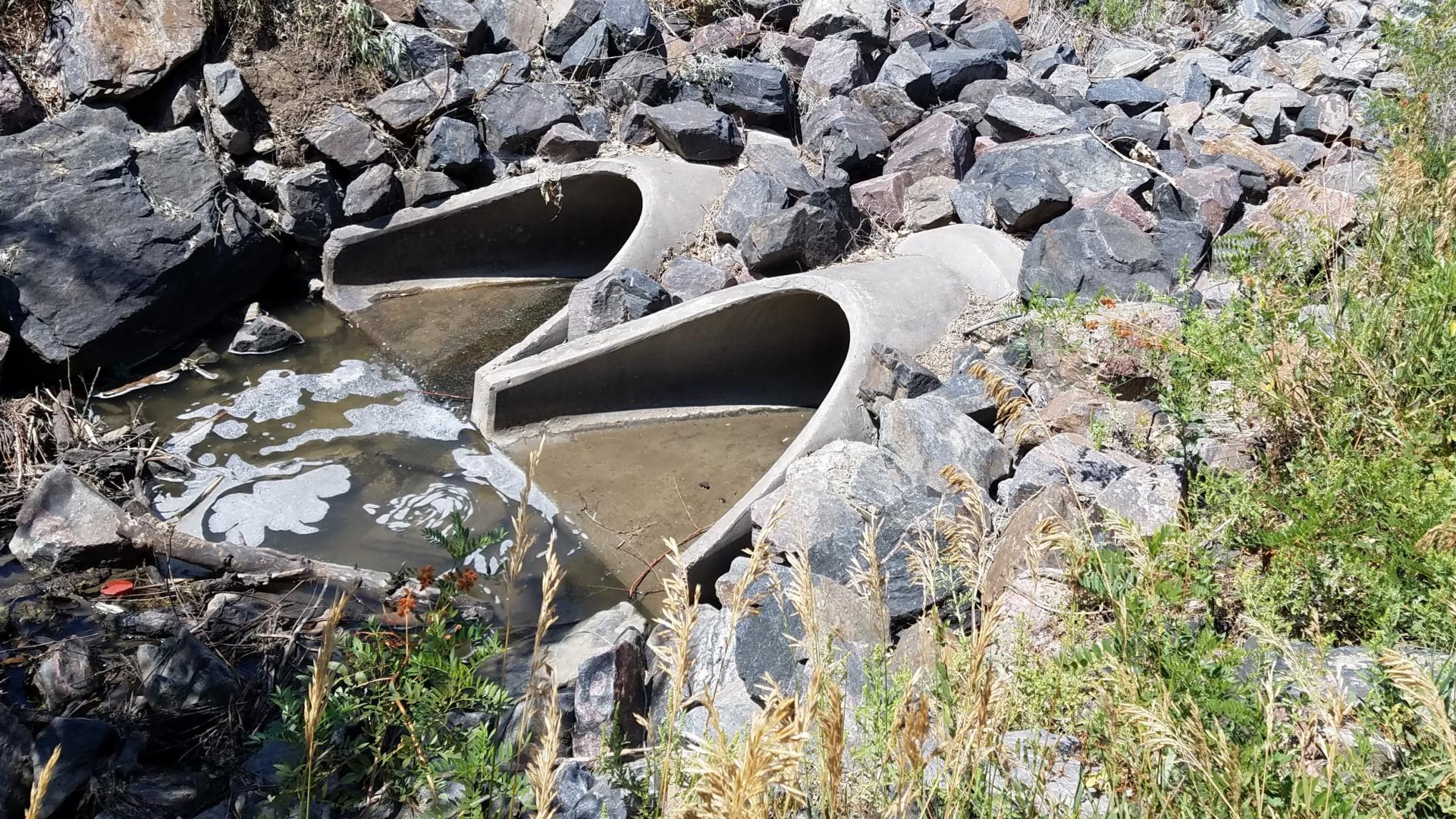 Stormwater outlet structure with murky water in it