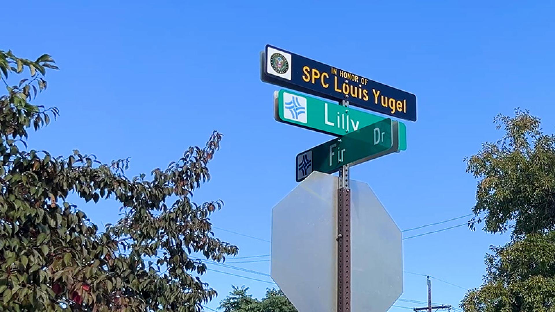 Honorary street name sign Specialist Four Louis Arthur Yugel (Lilly Drive).