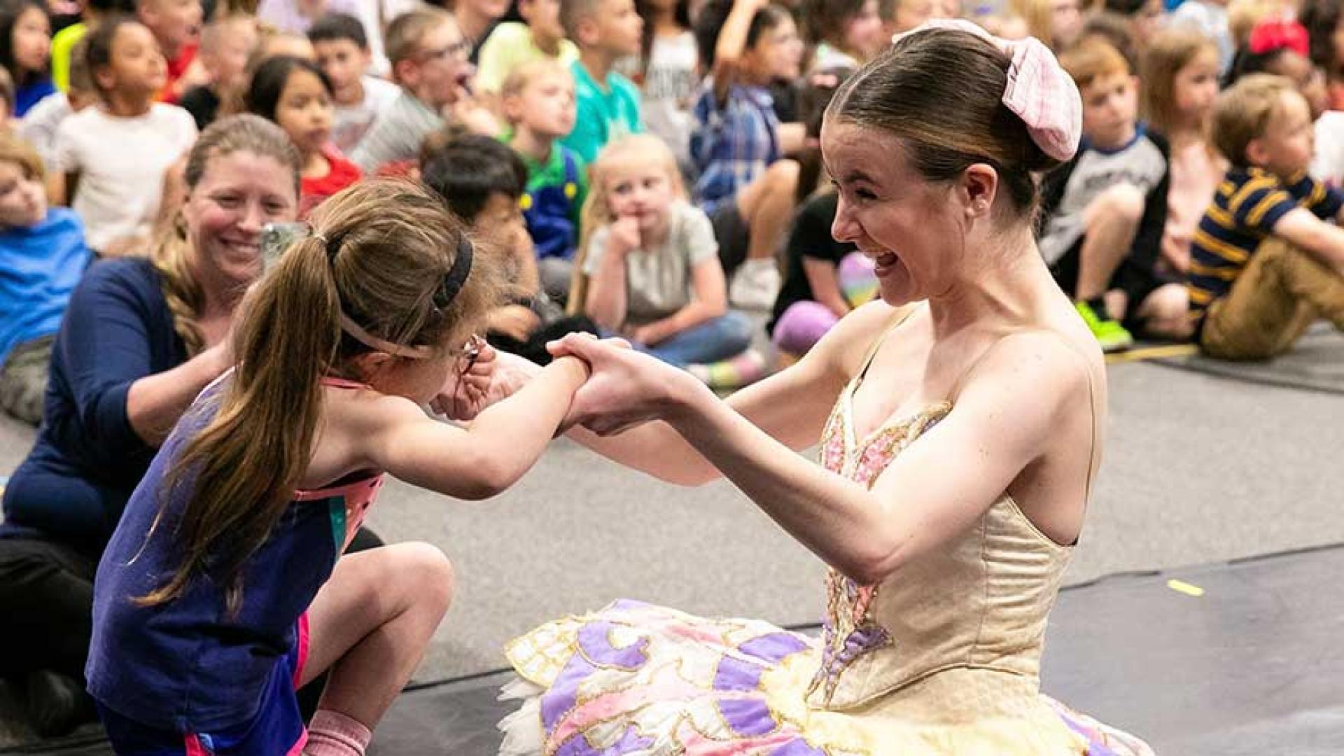 Female ballet dancer with child.