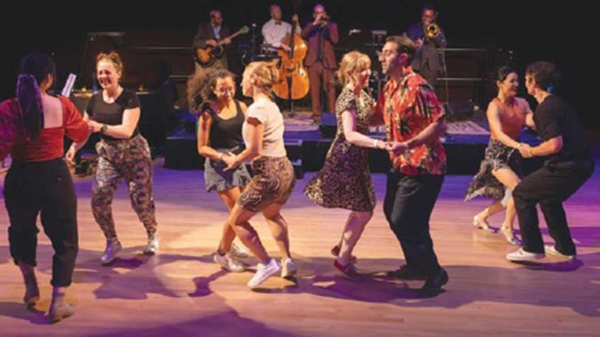 Couples dancing on stage.