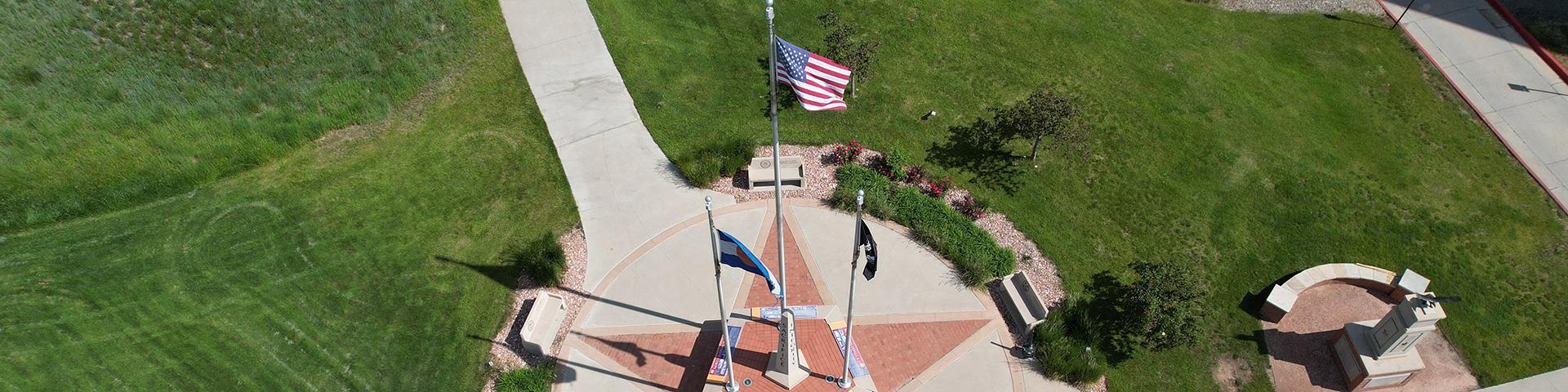 Aerial view of the five sided obelisk memorial in front of the Veterans Memorial Aquatic Center.