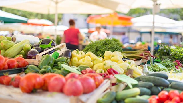 Many vegetables on a table at a Farmers Market.