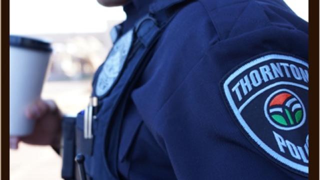 Police Officer holding a coffee cup