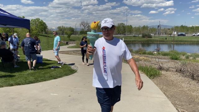 run participant holding torch