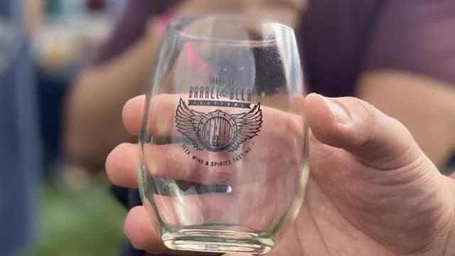 Close up of a hand holding a wine glass at the Barrel and Beer Festival.