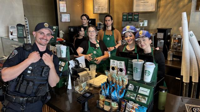 police officer standing at counter with coffee baristas