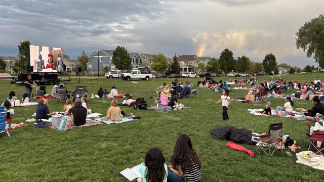 families on grass watching movie
