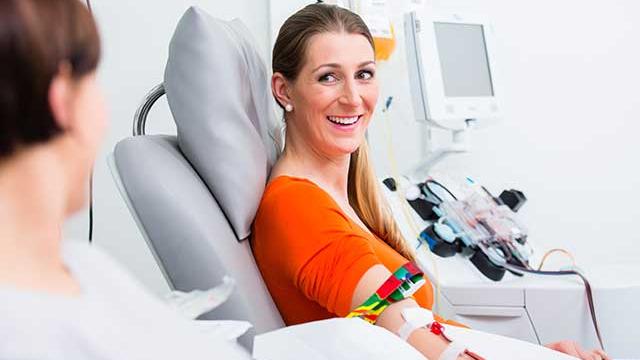 Woman sitting in a chair and donating blood.