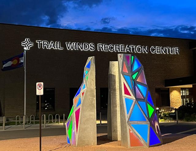 Trail Winds Recreation Center and art sculputre at night.