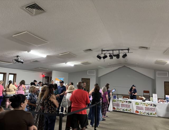 A group of people at a food box pickup on July 10, 2025.
