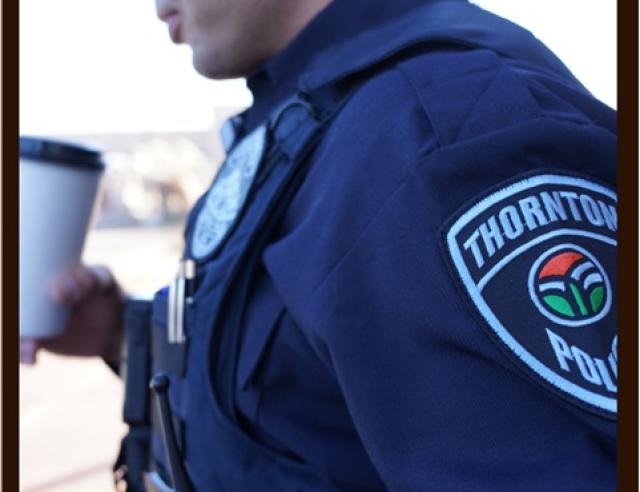Police Officer holding a coffee cup