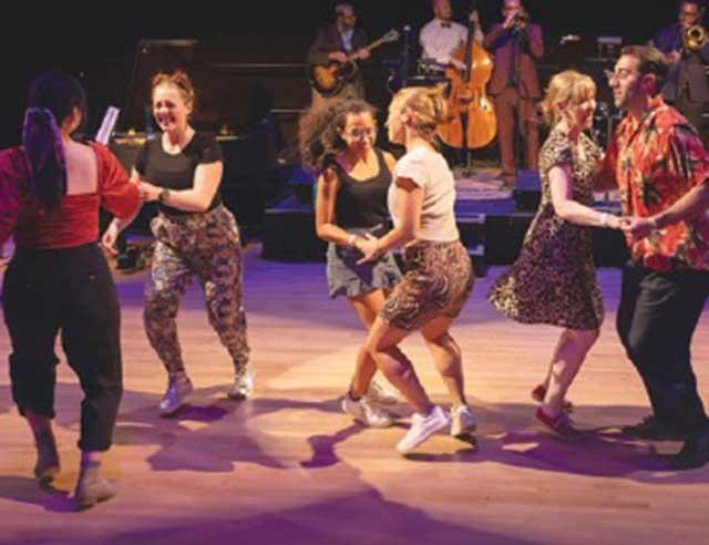 Couples dancing on stage.