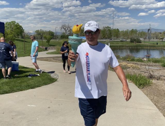 run participant holding torch