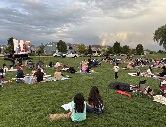 families on grass watching movie
